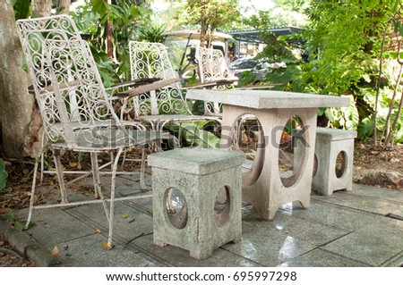Stone table and vintage chair in the garden.