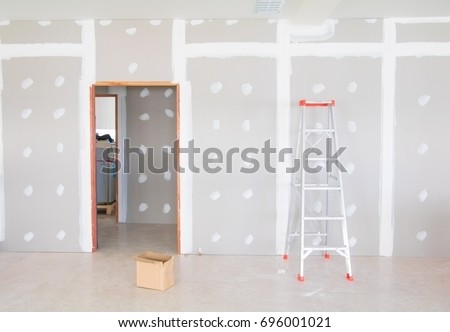 stair and gypsum board wall interior decoration of home at construction site with copy space add text Royalty-Free Stock Photo #696001021
