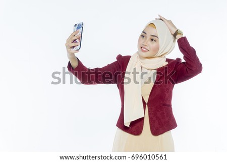 The young woman of Islam with a smartphone is pictured