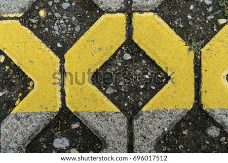 yellow marks on paving stone