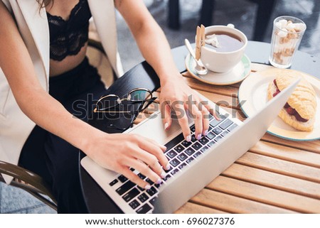 Business woman working alone with  laptop in cafe