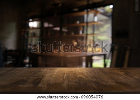 Empty wooden table in front of abstract blurred background of coffee shop . can be used for display or montage your products.Mock up for display of product Royalty-Free Stock Photo #696054076