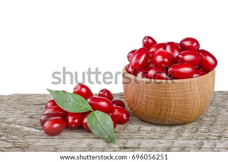 dogwood berry with leaf in bowl on wooden table with white background