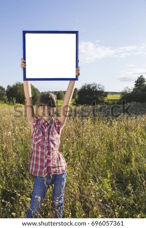 girl standing in field of flowers, holding an empty layout, mock up