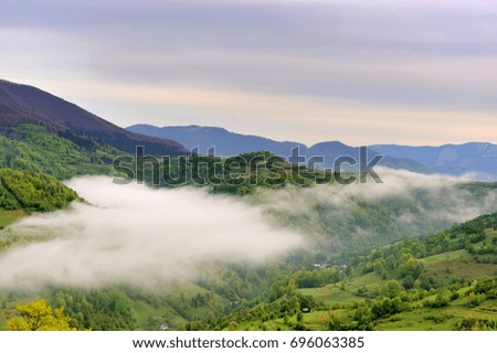 Mountains landscape with fog in summer morning