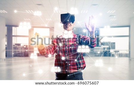 Young man with virtual reality headset or 3d glasses over social connection background . Mixed media