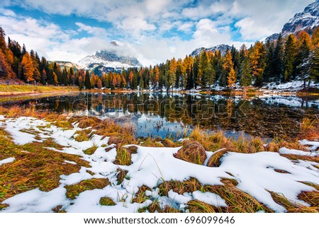 Splendid sunny scene on Antorno lake with Tre Cime di Lavaredo (Drei Zinnen) mount. Colorful autumn landscape in Dolomite Alps, Province of Belluno, Italy, Europe. Beauty of nature concept background
