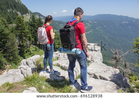Eco tourism and healthy lifestyle concept. Young hiker girl end boy with backpack. Active hikers