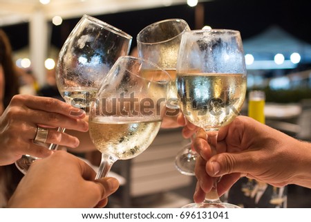 cheers with wine Royalty-Free Stock Photo #696131041