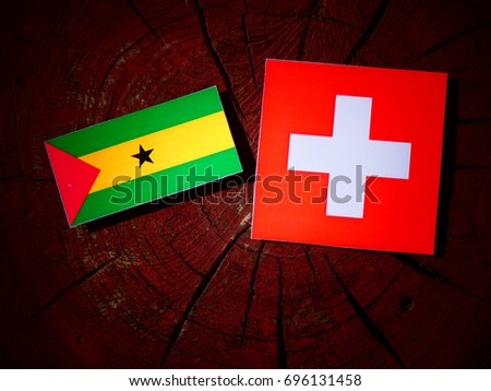 Sao Tome and Principe flag with Swiss flag on a tree stump isolated