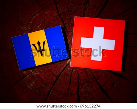 Barbados flag with Swiss flag on a tree stump isolated