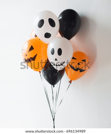 holidays, decoration and party concept - bunch of scary air balloons for halloween over white background