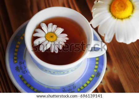 Natural tea with chamomile on a wooden table