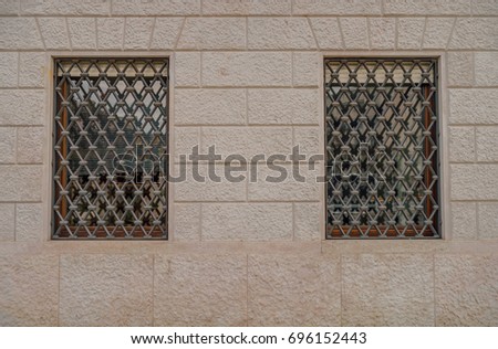 Vintage windows with decorative grills marble sandstone facade. Vintage effect. 