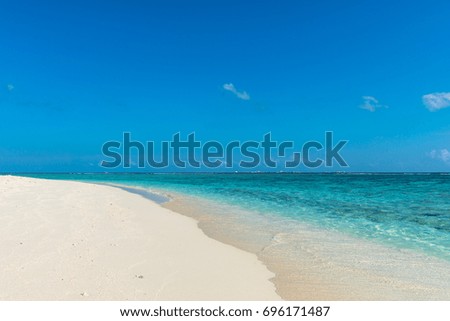 Horizontal picture of turquoise water with white sand beach during a sunny day in Maldives