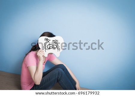 woman take cry tooth on blue background