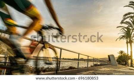 A professional cyclist is running his bike in the promenade of Majorca, Spain. Balearic Islands. 