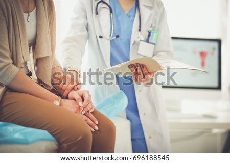 Doctor and patient discussing something while sitting at the table . Medicine and health care concept. Doctor and patient Royalty-Free Stock Photo #696188545