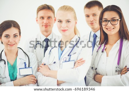 Portrait of group of smiling hospital colleagues standing together . Doctors