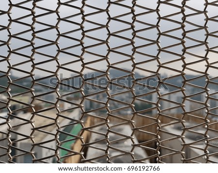 A small neighborhood in Seoul looking over a wire mesh