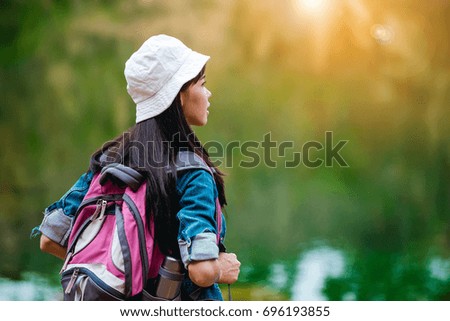 Young Asian girls with backpack enjoying the adventure.