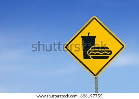 Burger with soft drink icon sign on yellow label, road signs,Traffic signs, on the sky background