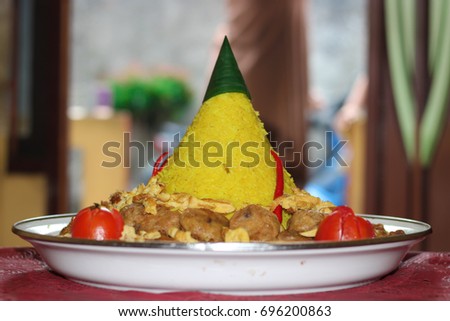 Rice cone traditional cuisine from Indonesia (Tumpeng) Royalty-Free Stock Photo #696200863