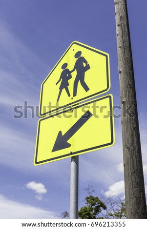 school zone sign in front of a blue sky