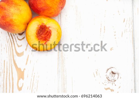 a lot of fresh peaches on a white table. Top view.