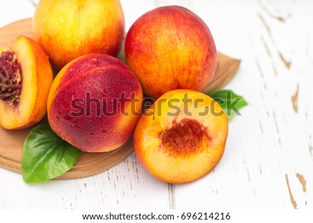 a lot of fresh peaches on a white table