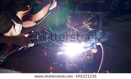 Welding workers with electric welding machines should check their health (soft focus).