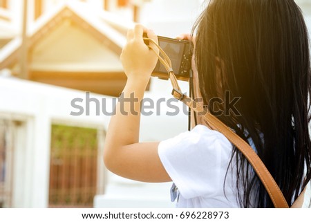 Child photographer, Asian girl happy holding camera,
