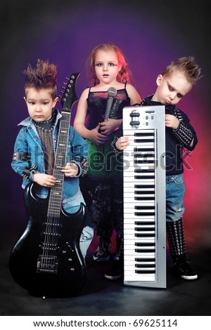 Group of children singing in heavy metal style. Shot in a studio.