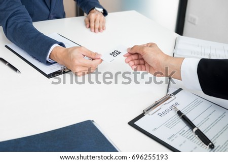 young businessman at the hiring interview in the office, meeting at office lobby, changing business cards
