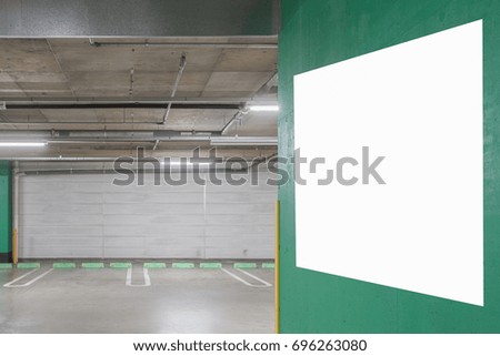 Parking garage underground interior with blank billboard
