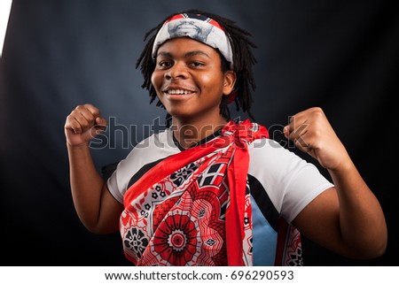 African man from Botswana smiling in a photo studio against a dark background happy