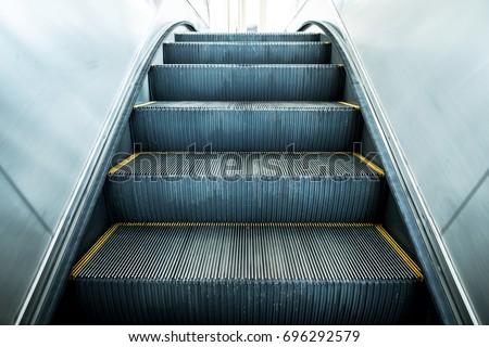 Modern escalator electronic system moving vintage filter Royalty-Free Stock Photo #696292579