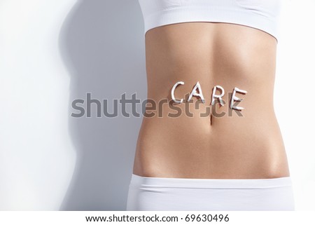 The word "care" in the abdomen of a young girl