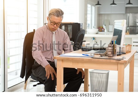asian senior business man sick at work