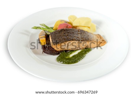 grilled salmon steak, grilled vegetables and pesto sauce on white background. clipping path