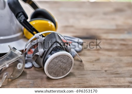 Standard construction safety equipment on wooden table. top view High Dynamic Range yone Royalty-Free Stock Photo #696353170