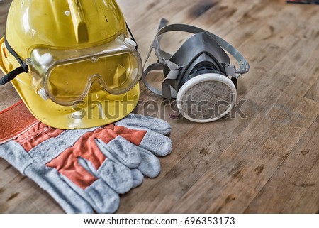 Standard construction safety equipment on wooden table. top view High Dynamic Range yone Royalty-Free Stock Photo #696353173
