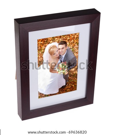 Photo frame with picture of happy couple on their wedding day