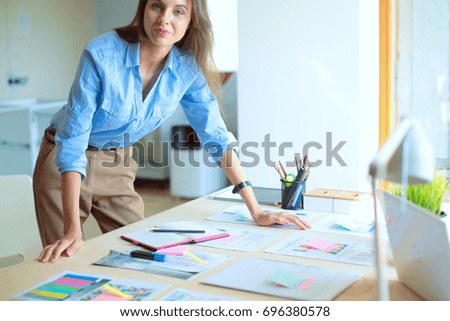 Young woman sitting at office table . Young woman.