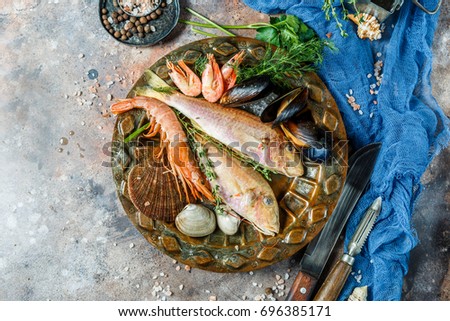 Photo on top of fresh seafood on plate with rosemary