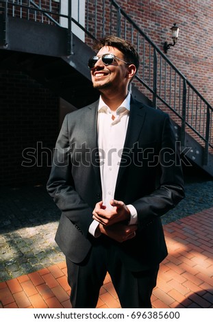 Man in sunglasses and black suit