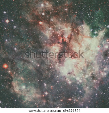 Tarantula Nebula is the star-forming region of ionised hydrogen gas is in the Large Magellanic Cloud, a small galaxy. Retouched image. Elements of this image furnished by NASA.