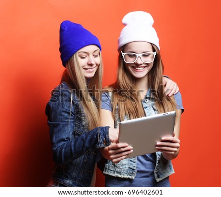 hipster girls friends taking selfie with digital tablet, studio 