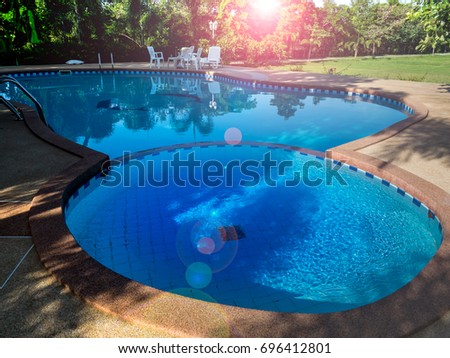 Swimming pool on sunset  Royalty-Free Stock Photo #696412801
