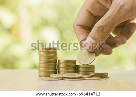 Saving money concept preset by Male hand putting money coin stack growing business